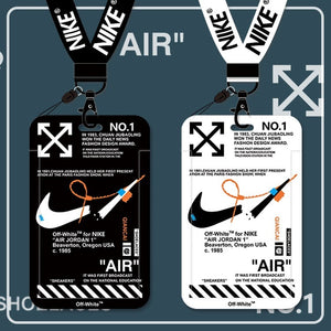 Two PVC card holder neck strap lanyards featuring Nike branding and design elements. One is black with white text and the other is white with black text and orange accents.