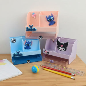Desk with cartoon-themed pencil holders and stationery items on a white background