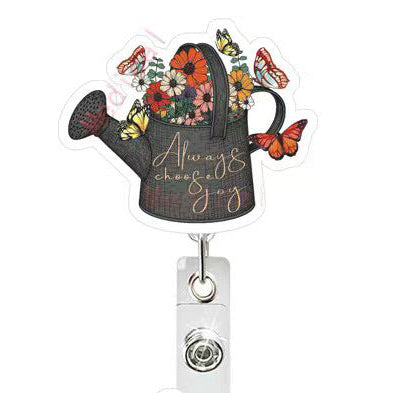 Decorative badge holder with a watering can design, flowers, and butterflies on a white background.