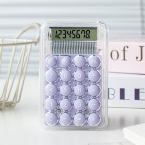 Purple calculator with a clear plastic cover on a light background