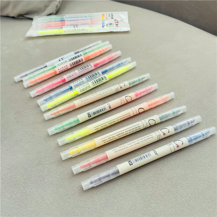 Set of colorful highlighters on a gray surface