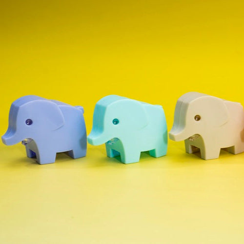 Four colorful elephant toys on a yellow background