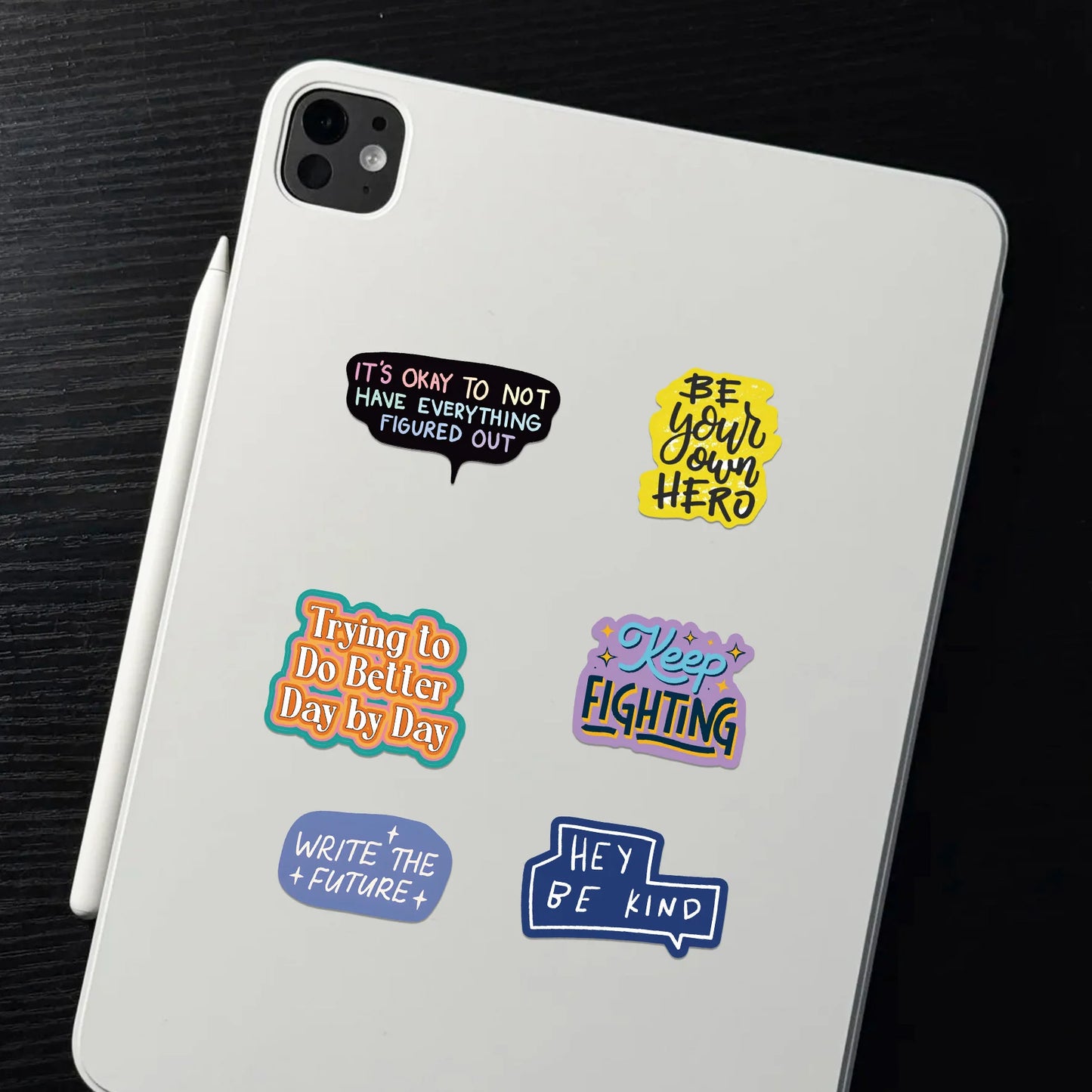 White tablet with motivational stickers on a dark surface