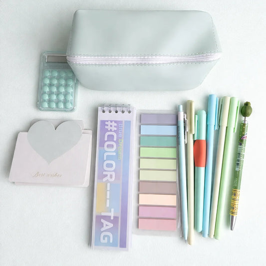 Assorted stationery items including pens, a notebook, and a pouch on a white background