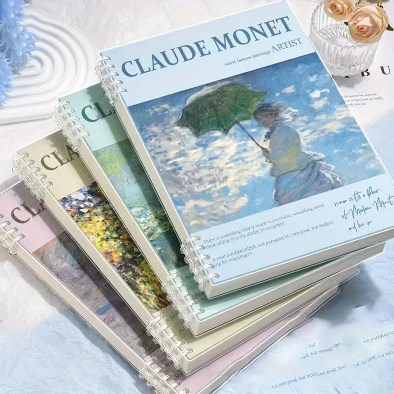 Stack of notebooks with Claude Monet cover design on a light surface