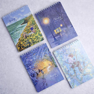 Four notebooks with artistic covers on a light gray background