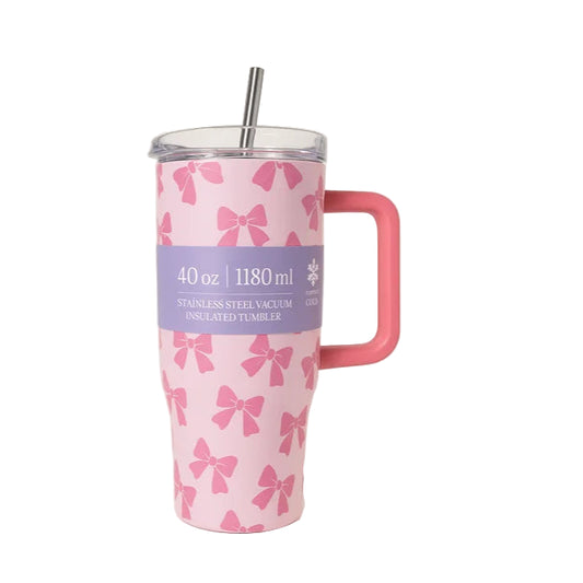Pink insulated tumbler with bow pattern and pink handle on a white background