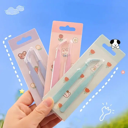 Three small tools in their packaging held by a hand against a blue sky background