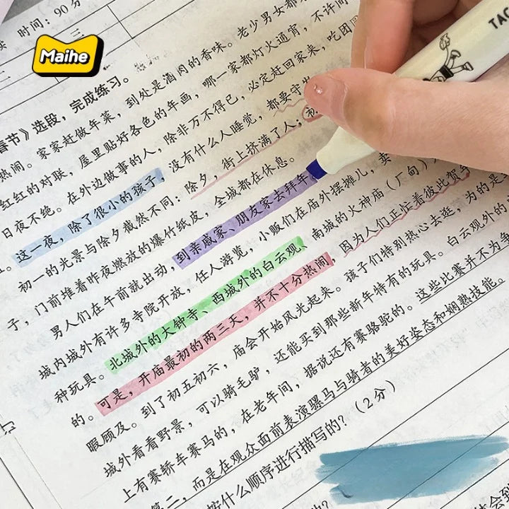 Hand holding a pen over a book with highlighted text, featuring the Maihe brand logo.