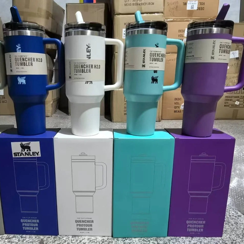 Five colorful tumblers on their respective boxes with 'Stanley' branding.