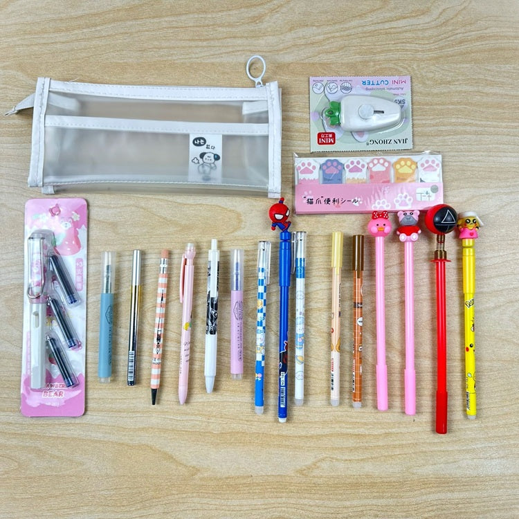 Assorted stationery items including pens and a pencil case on a wooden surface