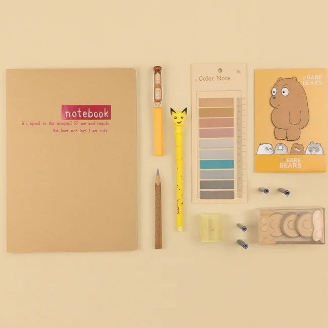 Notebook, pencils, and color swatches on a beige background