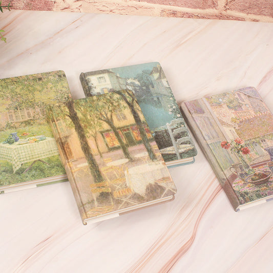 Three notebooks with artistic covers on a textured surface