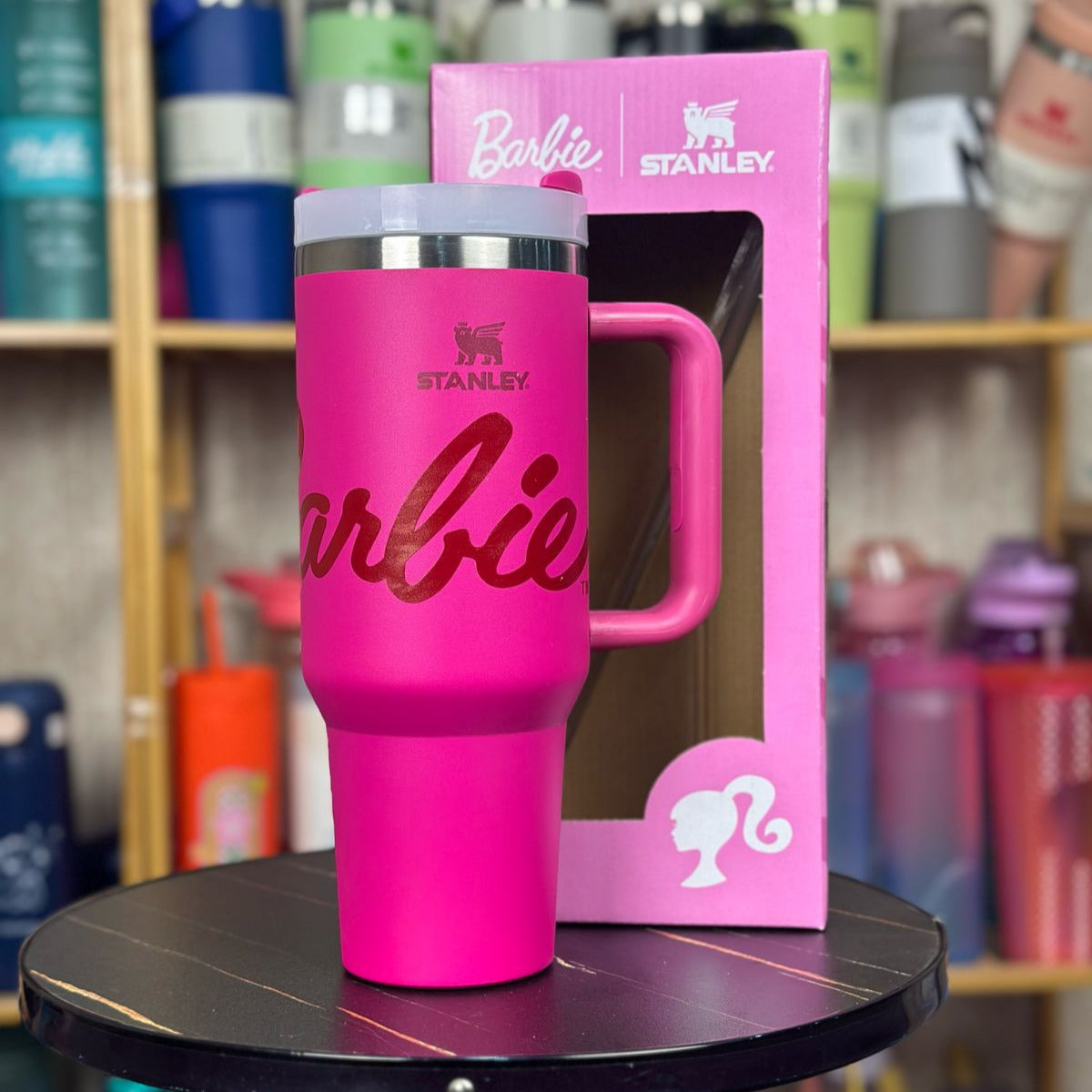 Pink Stanley Barbie tumbler with packaging on a table