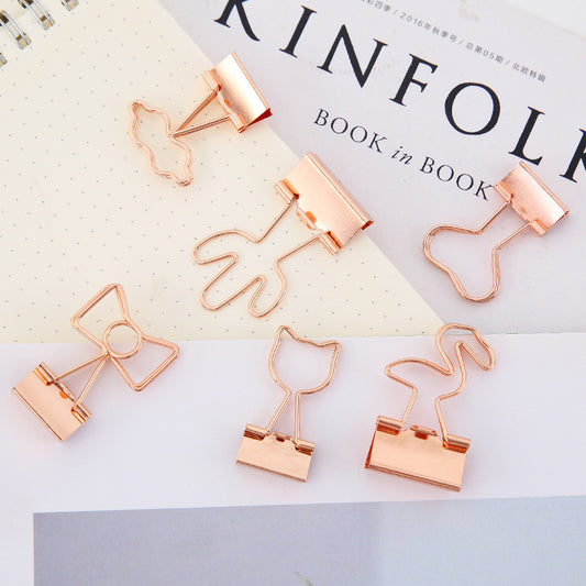 Rose gold paper clips on a magazine with 'KINFOLK' branding