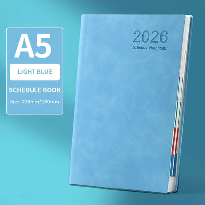 Light blue A5 schedule notebook with '2026' on a teal background