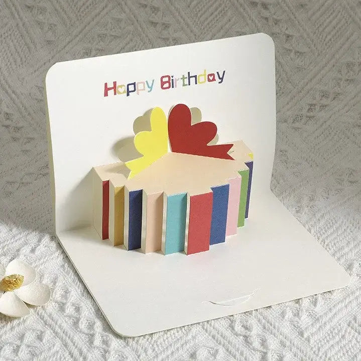 Colorful birthday card with a pop-up design on a textured surface.