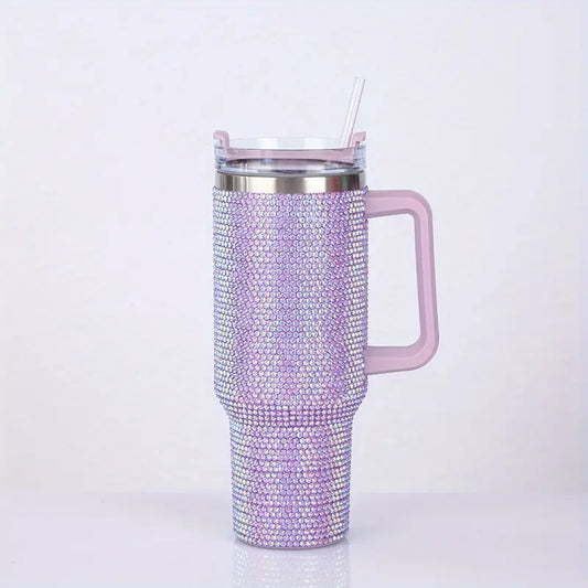 Pink tumbler with rhinestone embellishments on a white background