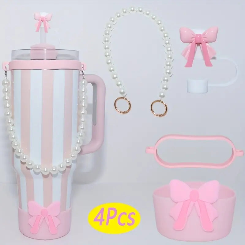 Set of pink accessories including a tumbler, bow-shaped items, and a necklace on a light gray background.