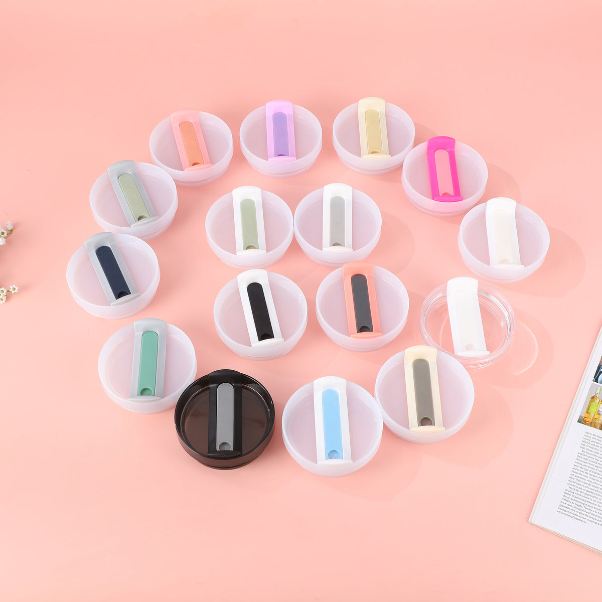Set of colorful markers in transparent containers on a pink background