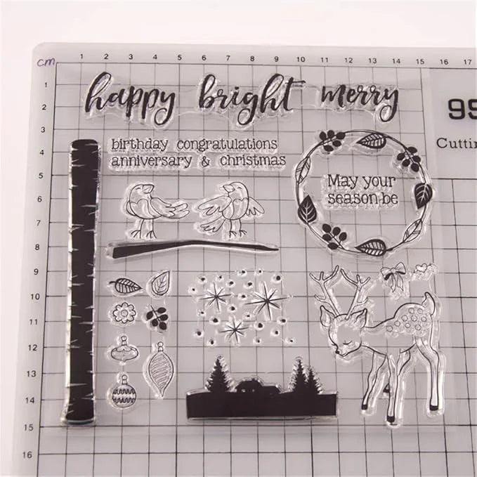 Set of clear stamps with various designs including a deer, trees, and text on a grid background.