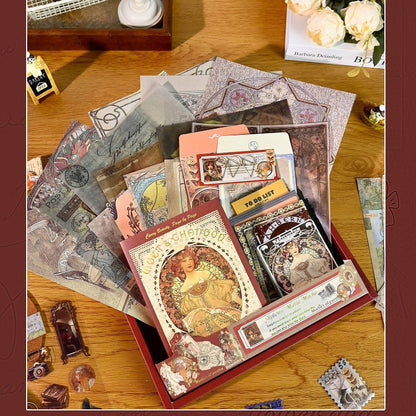 Collection of vintage-style greeting cards and stationery items on a wooden surface with a decorative border.