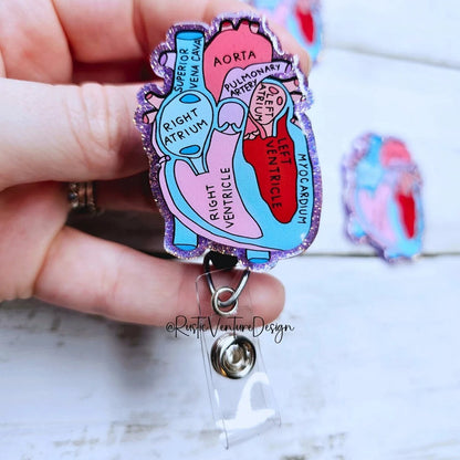 Heart diagram badge holder held by a hand on a light background