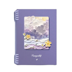 Purple notebook with a scenic cover design on a white background