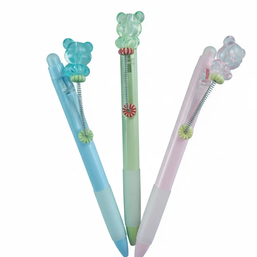 Three colorful pens with decorative elements on a white background