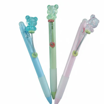 Three colorful pens with decorative elements on a white background