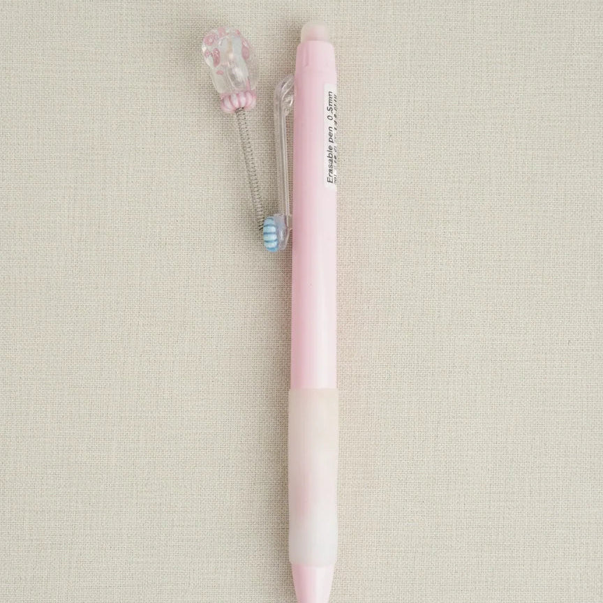 Pink pen on a beige background