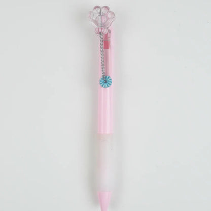 Pink and clear pen with decorative elements on a light gray background