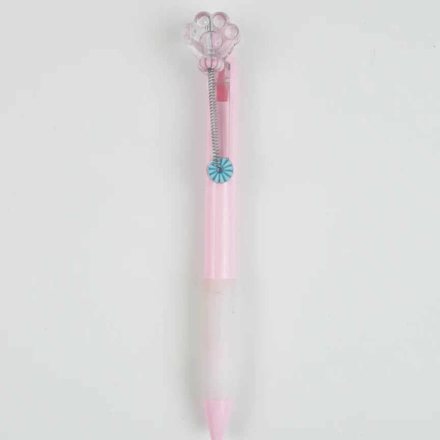 Pink and clear pen with decorative elements on a light gray background