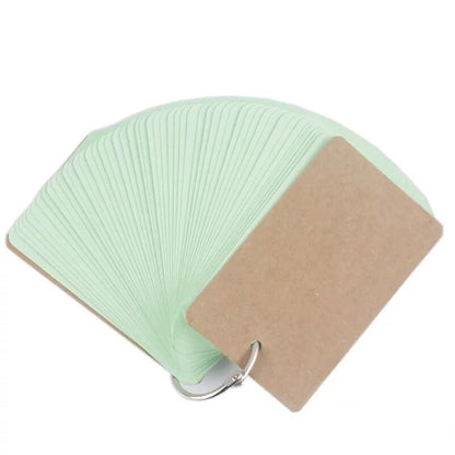 Green and brown fan-shaped product with a metal clip on a white background