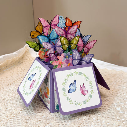 Decorative box with colorful butterflies and flowers on a textured surface