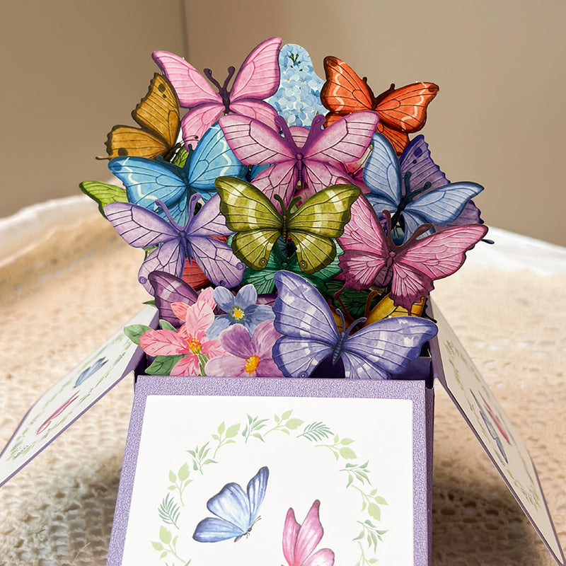 Colorful butterfly and flower arrangement on a decorative box with a woven background