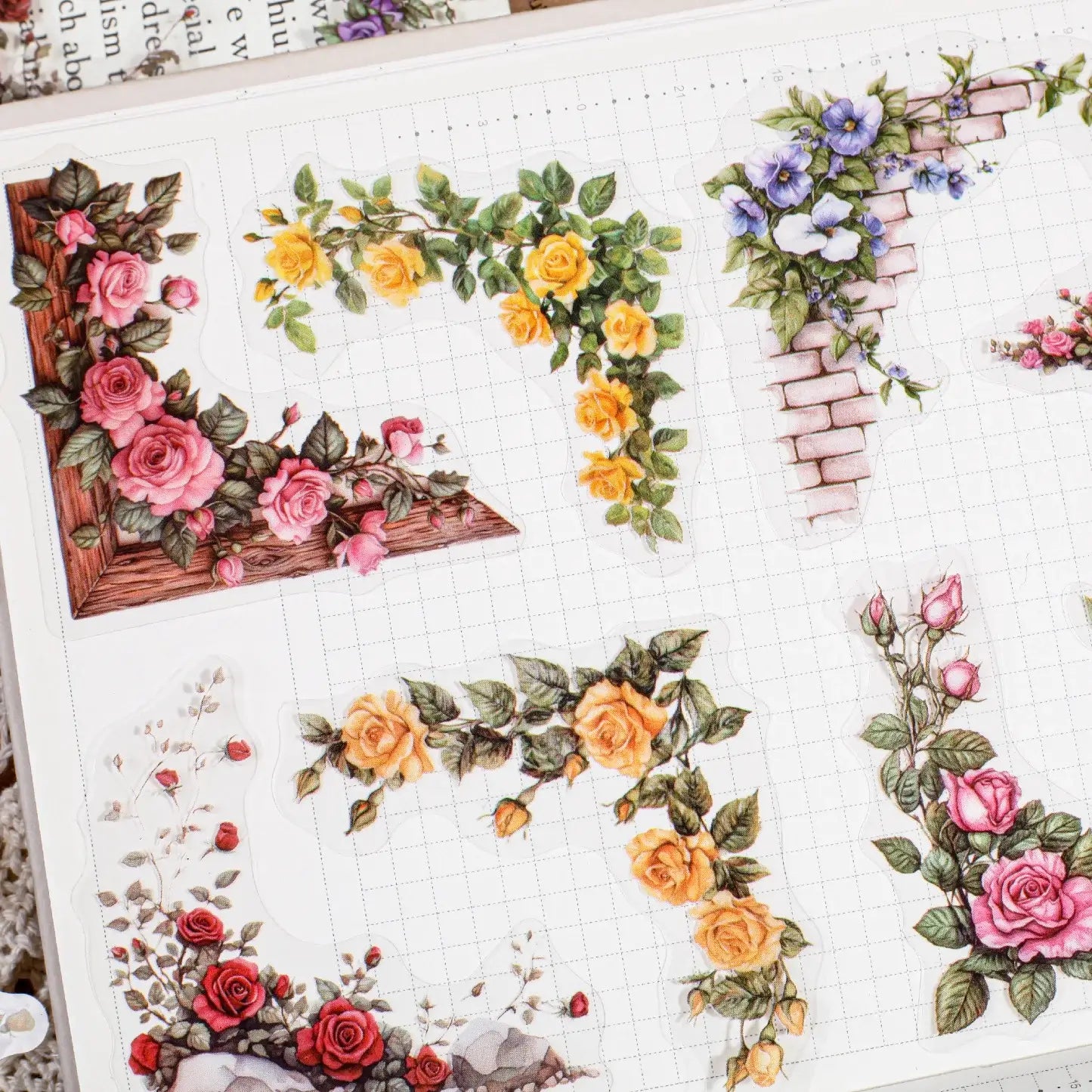 Decorative floral stickers on a grid paper background