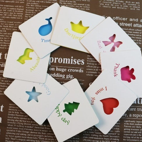 Colorful playing cards with symbols on a newspaper background