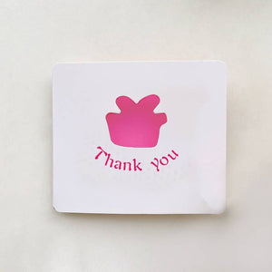 White card with pink cupcake icon and 'Thank you' text on a light beige background