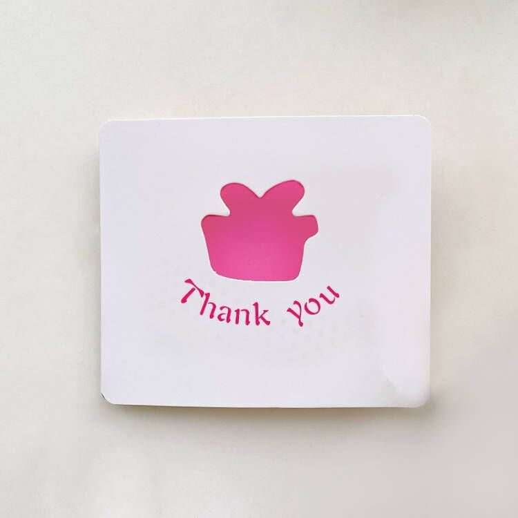 White card with pink cupcake icon and 'Thank you' text on a light beige background