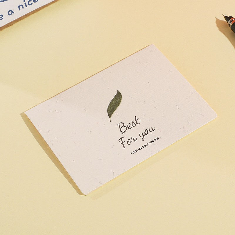 Greeting card with a leaf design and text on a yellow background