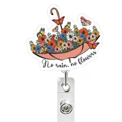 Decorative badge holder with floral design and motivational quote on a white background