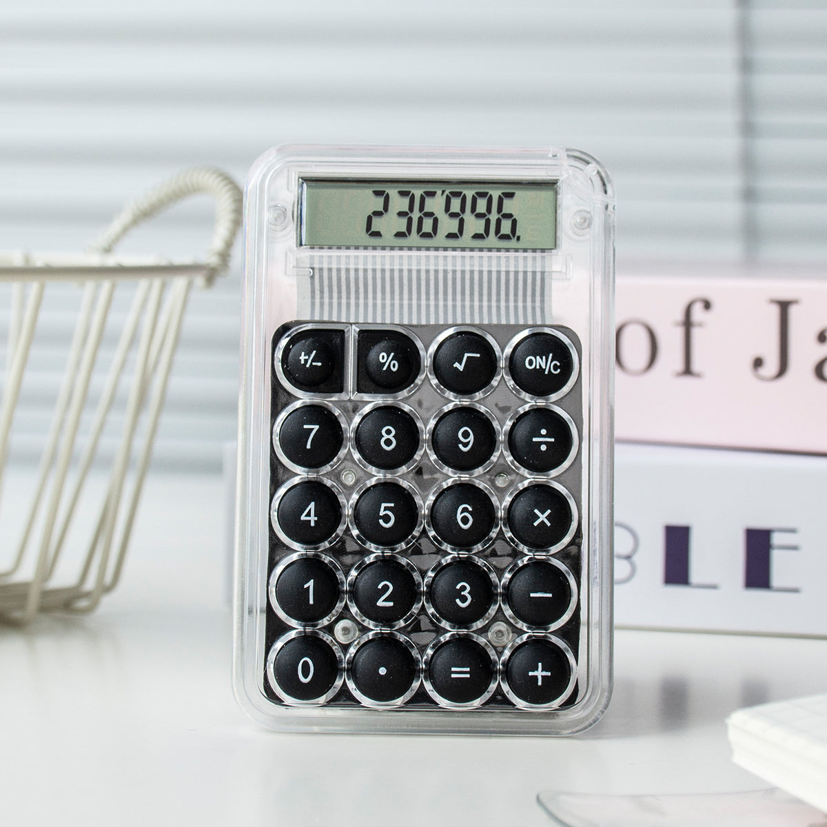 Small calculator with black buttons on a white surface