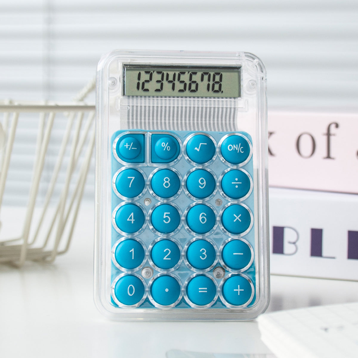 Calculator with blue buttons on a white surface