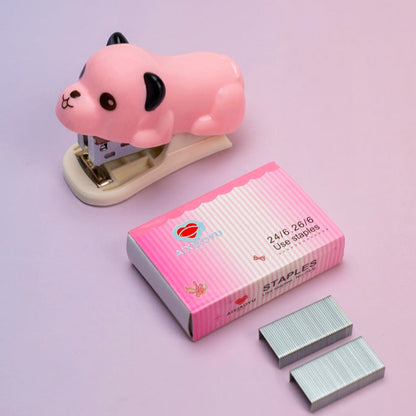 Pink cartoon-style stapler with a box of staples on a light purple background