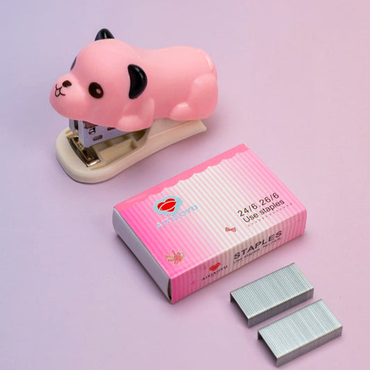 Pink cartoon-style stapler with a box of staples on a light purple background