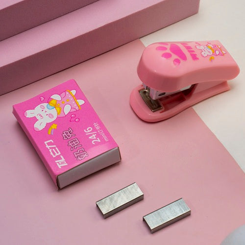 Pink stapler with cartoon design on a pink surface