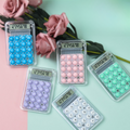 Set of colorful calculators with bead designs on a pastel background