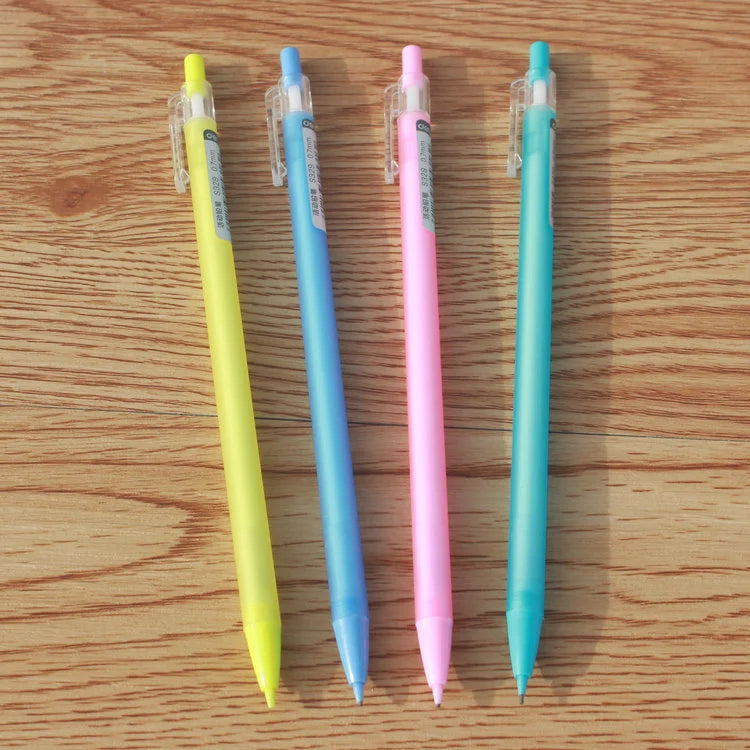 Four colorful pens on a wooden surface