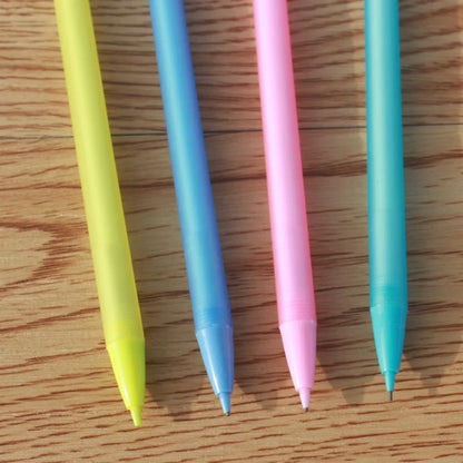 Four colorful pens (yellow, blue, pink, and light blue) on a wooden surface.